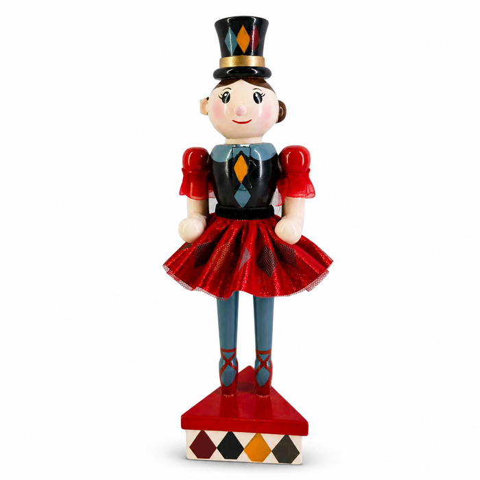 Harlequin nutcracker figure in red, black, and teal, wearing a diamond-patterned top hat and tulle skirt
