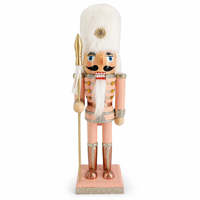 Rose gold soldier nutcracker in pink and white, with fur hat and gold spear