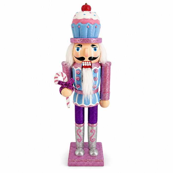 Cupcake nutcracker in pastel blue and purple, with cupcake hat and candy cane accessory
