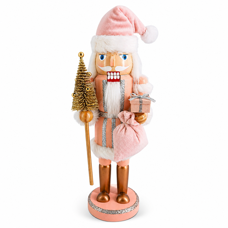 Pink Santa nutcracker figure in pink and silver, holding a gift sack and small gold tree