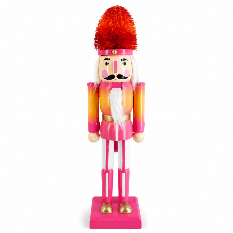 Sunset ombre soldier nutcracker figure in pink and orange, with an orange and red ombre bottle brush hat