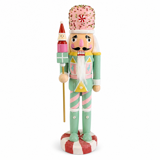 Pastel toy guard nutcracker figure in mint and pink, holding a gift staff with a Santa topper