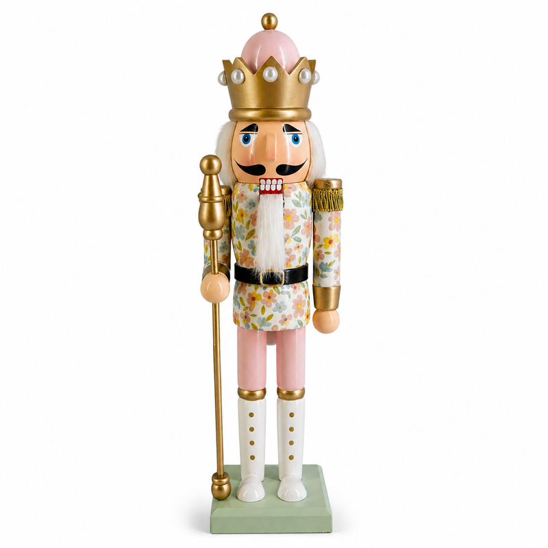 Floral king nutcracker figure in pink and gold, wearing a pearl-topped crown