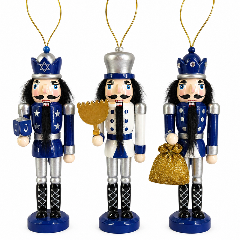 Set of three Hanukkah nutcracker ornaments in blue, white, and silver, with dreidel, menorah, and gift sack accessories
